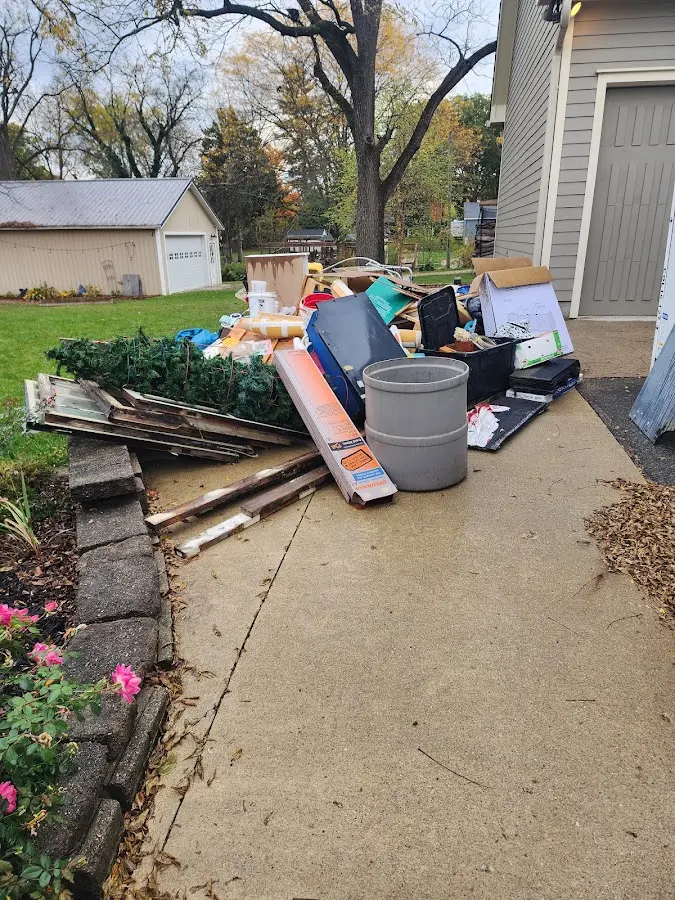 Dumpster being loaded with debris for Estate Cleanout Dumpster Rental in Pownal